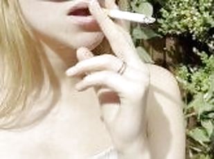 Blonde teen is smoking and spitting loogies coughing hocking phlegm with long tongue