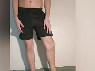 A guy shows what a chastity belt looks like under his clothes - a chastity cage in shorts