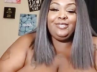 Obese chocolate lady rubs her extra giant boobs