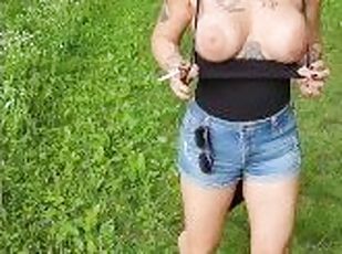 Out in the woods, smoking a cigarette and letting those massive tits free