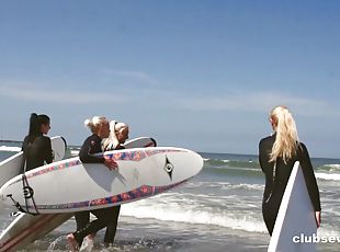 Four hot surfer girls eat pussy in the sand during a foursome