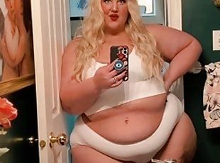 The chubby princess talks and shows her soft and fat body in the bathroom mirror.