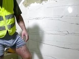 Horny construction worker install tile with bulge